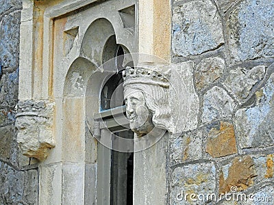 Gargoyles gargoyle heads faces grotesque window fort church castle Stock Photo