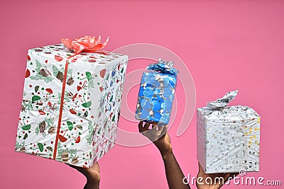 photo of people holding up gift boxes and present over their heads, hands only Stock Photo