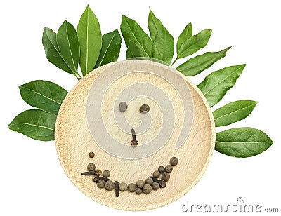 Photo of pepper corns and green aromatic bay leaf branch on the bamboo plate, isolated on white. Laurel twigs. Photo of laurel bay Stock Photo