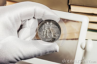 Photo of a person's hand in gloves holding a soviet ruble coin Stock Photo