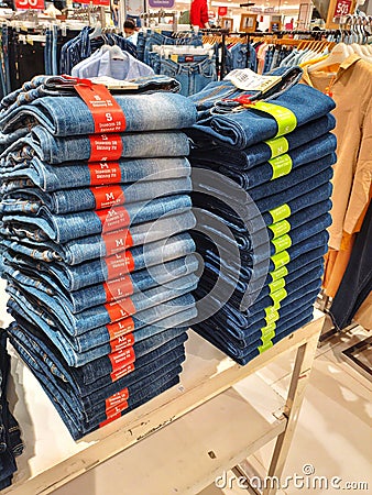 This is a photo of a pile of jeans in a supermarket Editorial Stock Photo