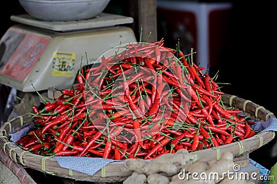 Photo of a pile of very spicy cayenne chili peppers in the basket. Stock Photo