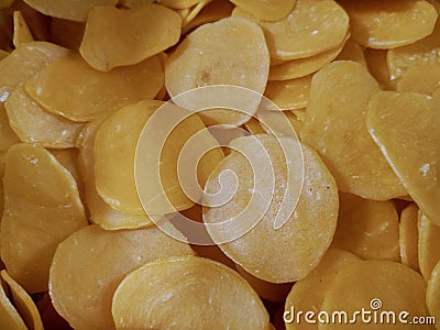 Photo of a pile of yellow shrimp crackers at a vegetable stall in a traditional market in Indonesia Stock Photo