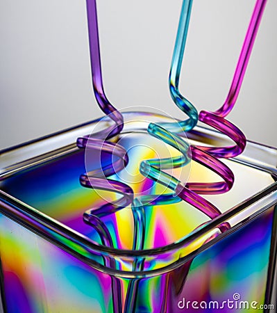 Photo of an plastic recipient and colourful straws. Stock Photo