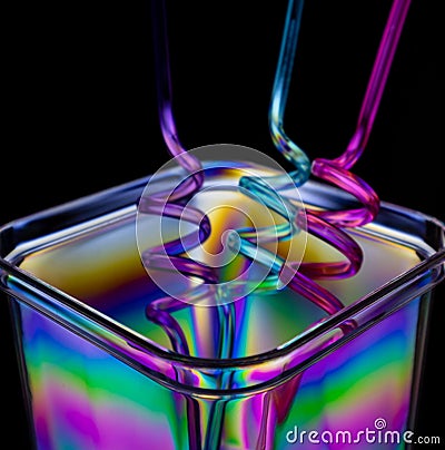 Photo of an plastic recipient and colourful straws. Stock Photo