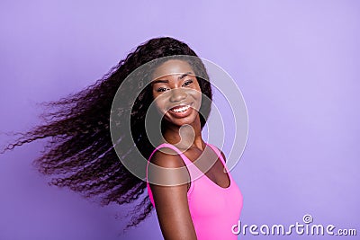 Photo portrait of african american smiling girl swinging hair on pastel pink colored background Stock Photo