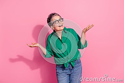 Photo portrait of attractive pensioner woman shrug shoulders mistake oops wear trendy green clothes isolated on pink Stock Photo