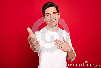 Photo portrait brunet in white shirt friendly giving hand isolated vivid red color background Stock Photo