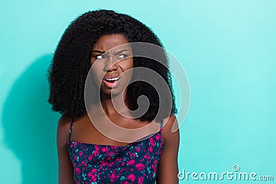 Photo portrait of curious misunderstanding girl displeased unhappy looking empty space isolated on vibrant teal color Stock Photo