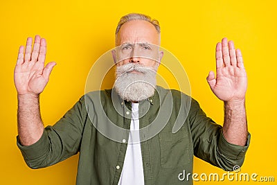 Photo portrait of elder man serious showing stop enough sign with hands isolated vivid yellow color background Stock Photo