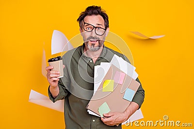 Photo portrait exhausted man at work in glasses flying documents behind isolated bright yellow color background Stock Photo