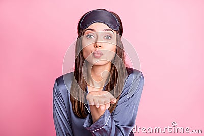 Photo portrait of flirty girl sending air kiss from hand isolated on pastel pink colored background Stock Photo