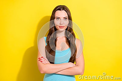 Photo portrait girl with long hair wearing casual outfit serious crossed hands vibrant yellow color background Stock Photo