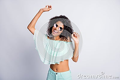Photo portrait of happy cheerful mulatto girl with curly hairstyle wearing sunglass mint outfit dancing isolated on grey Stock Photo
