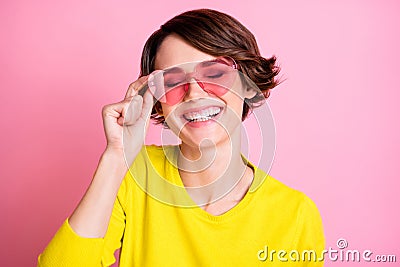 Photo portrait of happy girl wearing heart shaped glasses laughing overjoyed isolated on pastel pink color background Stock Photo