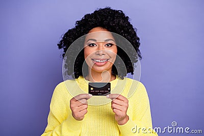 Photo portrait of lovely young lady hold credit card bank client wear trendy yellow garment isolated on purple color Editorial Stock Photo