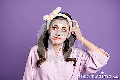 Photo portrait of unsure misunderstanding girl looking at empty space in headband touching head isolated vivid purple Stock Photo