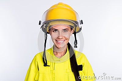 Photo of positive cheerful young firewoman dressed yellow uniform helmet smiling isolated white color background Stock Photo