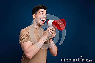 Photo of positive man wear trendy clothes announce news black friday say hurry up look empty space isolated on dark blue Stock Photo
