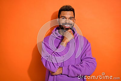 Photo of positive minded man hold arm hand hold chin imagine good shopping day isolated on orange color background Stock Photo