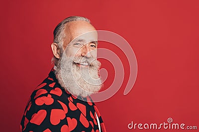 Photo of positive pensioner old man look camera toothy beaming smile wear heart print tux isolated red background Stock Photo