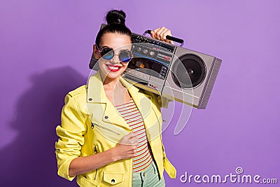 Photo of positive youngster lady hold shoulder boom box over violet color background Stock Photo