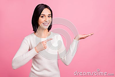 Photo of pretty business lady indicating finger on open palm presenting novelty wear white pullover isolated pink bright Stock Photo