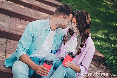 Photo of pretty dreamy husband wife dressed casual clothes drinking hot berages enjoying sunshine outside backyard Stock Photo