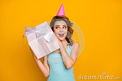 Photo of pretty funny lady hold big giftbox hands unexpected present try to guess what inside wear pink paper birthday Stock Photo