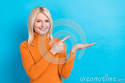 Photo of promoter woman blonde hair wear orange turtleneck hold palm direct finger cheap food ad novelty isolated on Stock Photo