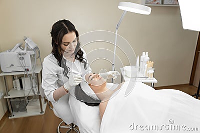 The photo reflects the magical atmosphere and gentle process of facial skin peeling, which improves the skin of the face Stock Photo