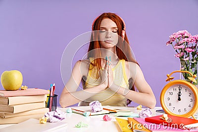 Photo of relaxed student girl in headphones holding palms together Stock Photo