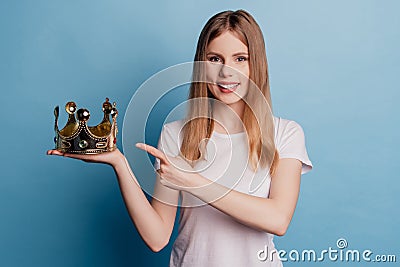 Photo of reliable charming nice dream queen lady direct finger golden crown on blue color background Stock Photo