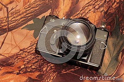 Photo of retro camera on the camouflage Stock Photo