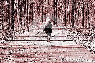 Photo in retro style depicting running child on road in spring forest Stock Photo