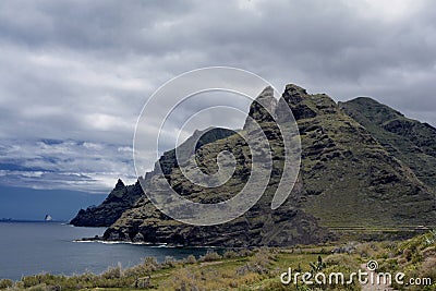 Photo of a rugged mountain jutting into the sea Stock Photo