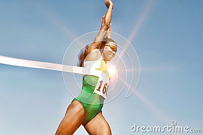 Portrait of Runner Breaking Finish Line Tape Stock Photo