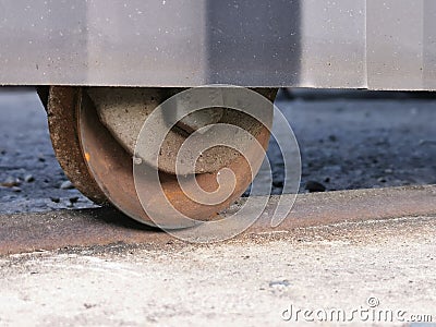 Photo of rusty heavy duty metal fence roller wheel. Stock Photo