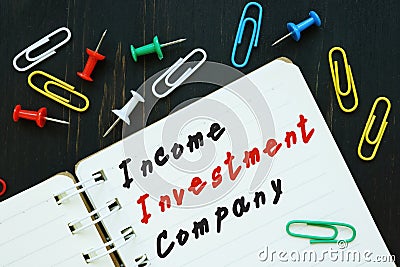 The photo says Income Investment Company. Notepad, pen, marker Stock Photo