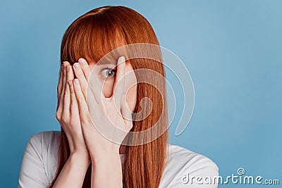 Photo of scared girl close palm mouth isolated on blue background Stock Photo