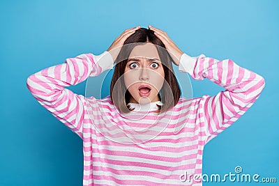 Photo of scared impressed woman wear striped sweater arms head open mouth isolated blue color background Stock Photo