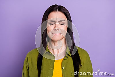 Photo of scared impressed young woman wear khaki outfit closed eyes biting lips isolated violet color background Stock Photo