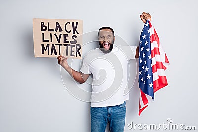 Photo of screaming mad dark skin american protester hold placard usa flag standing city square against afro lawlessness Editorial Stock Photo