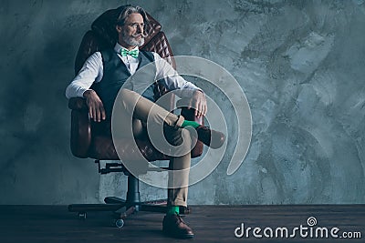 Photo of senior model macho business man neat beard sitting cozy big boss chair wear specs stylish shirt waistcoat pants Stock Photo