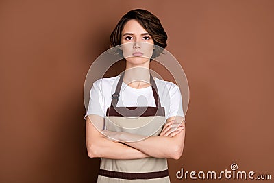 Photo of serious charming person folded arms look attentively camera on brown color background Stock Photo