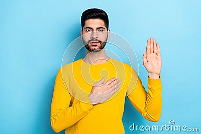 Photo of serious confident man wear yellow sweater promising tell truth isolated blue color background Stock Photo