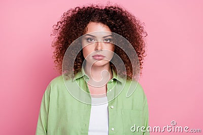 Photo of serious confident pleasant woman with perming coiffure dressed green shirt look at camera isolated on pink Stock Photo
