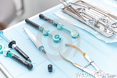 Photo of a set of steril dentistry tools or instruments lying on a table. Stock Photo