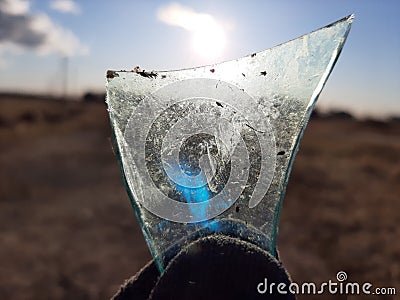 photo of a shard of glass against the sun Stock Photo