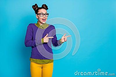 Photo of shocked impressed pretty student lady two buns direct fingers empty space showing novelty wear specs shirt Stock Photo